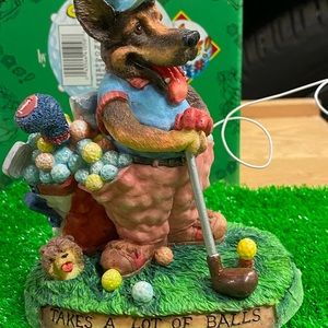 Enesco New with box, dog playing golf statue.